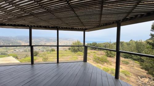 a room with a wooden deck with a view at La madriguera Matanzas in Navidad