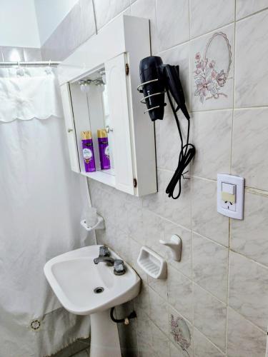 a bathroom with a sink and a phone on the wall at Huerta Grande 2 in Huerta Grande