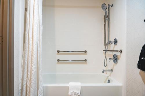 a white bathroom with a tub and a shower at Holiday Inn Express Frazer - Malvern by IHG in Frazer