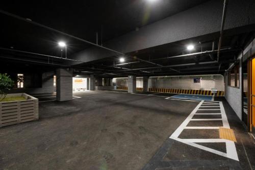 an empty parking lot in a parking garage at night at Hound Hotel Yeonsan in Busan