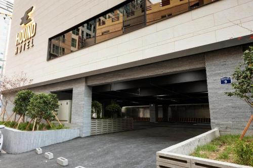 a parking lot in front of a building at Hound Hotel Yeonsan in Busan