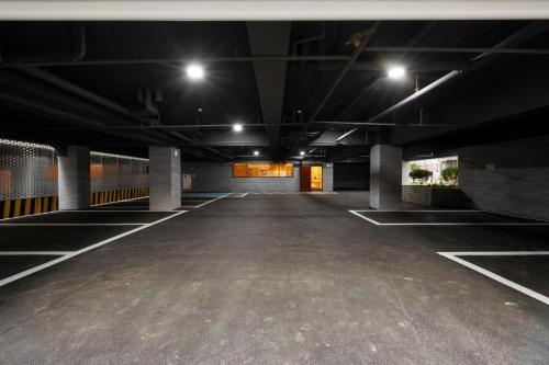 an empty parking lot with lights in a parking garage at Hound Hotel Yeonsan in Busan