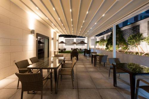a restaurant with tables and chairs on a building at Hound Hotel Yeonsan in Busan