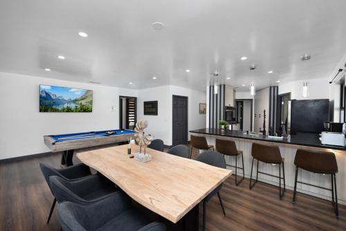 a dining room with a pool table and chairs at Off Grid Mountaintop Paradise Pool Spa and Games in San Bernardino