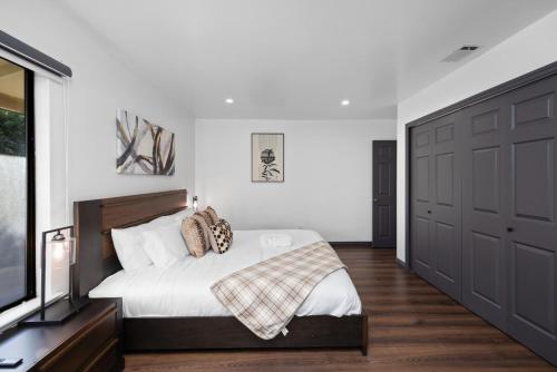a bedroom with a large bed and a television at Off Grid Mountaintop Paradise Pool Spa and Games in San Bernardino