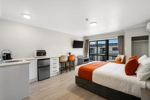 a hotel room with a bed and a kitchen at Stay 280 & Stay 284 Rotorua - Refurbished Modern Accommodation in Rotorua