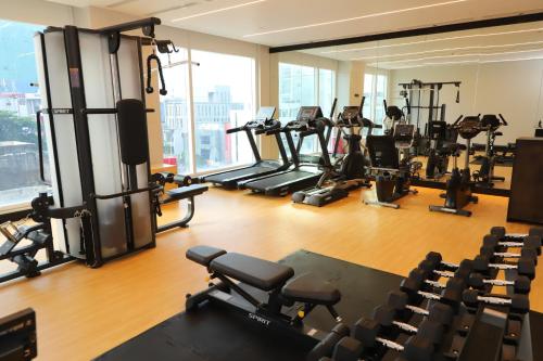 a gym with a lot of treadmills and machines at Sofia Colombo City Hotel in Colombo