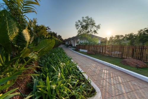 a walkway in a yard with a fence at SinQ Anvaya in Maem