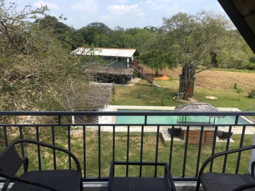 a view of a pool from a balcony at Lake10 Eluwankulama in Mulakandaveli