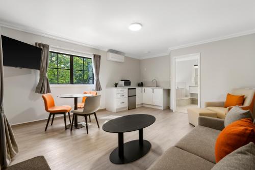 a living room with a couch and a table at Stay 280 & Stay 284 Rotorua - Refurbished Modern Accommodation in Rotorua