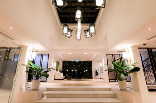 a lobby with potted plants in a building at Montgomerie Links Hotel & Villas in Hoi An