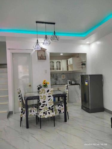 a dining room with a table and chairs and a kitchen at Compostela Two Story Richwood Townhome Breakfast Offered in Compostela