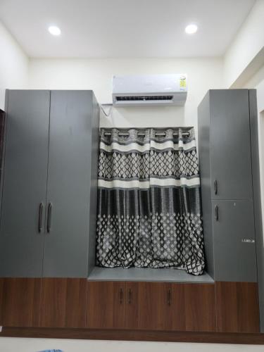 a room with a window with a curtain at Just Launched Cute Studio 2 BHK Flats in Kondapur Near Botanical Garden & Sarath City Capital Mall in Kondapur