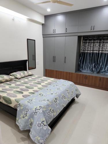 a bedroom with a bed and cabinets in it at Just Launched Cute Studio 2 BHK Flats in Kondapur Near Botanical Garden & Sarath City Capital Mall in Kondapur