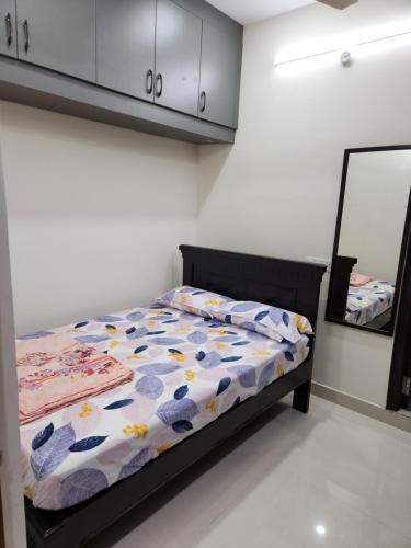 a bedroom with a bed and a mirror at Just Launched Cute Studio 2 BHK Flats in Kondapur Near Botanical Garden & Sarath City Capital Mall in Kondapur