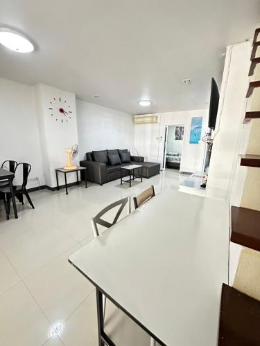 a living room with a couch and a table at NB bangsaen house KL2 in Ban Puk (2)