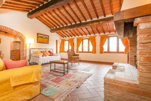 ein Wohnzimmer mit einem Sofa und einem Kamin in der Unterkunft Borgo La Grancia in Montisi