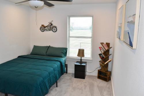 a bedroom with a bed and a motorcycle on the wall at 4-Bed Home, Prime Houston Location in Houston
