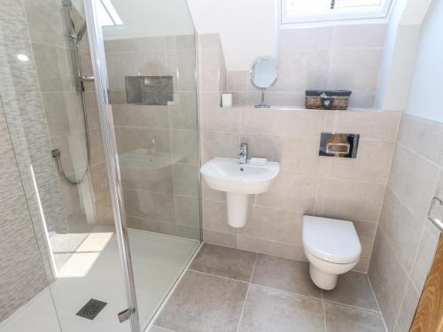 a bathroom with a toilet and a sink and a shower at Woodland View in Richmond