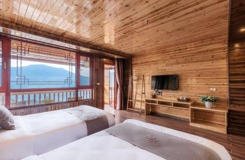 Postel nebo postele na pokoji v ubytování Longji Yijingyuan Hotel