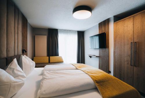 Postel nebo postele na pokoji v ubytování Grünwald Resort Sölden