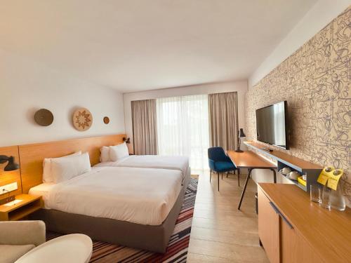 a hotel room with a bed and a desk at Holiday Inn - Lusaka by IHG in Lusaka