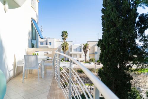 a balcony of a house with a table and chairs at MARIMAR - Apartments OTRANTO in Otranto