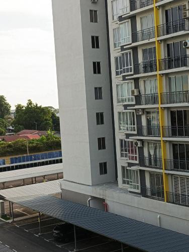 a bench in front of a tall building at mazya homestay in Melaka