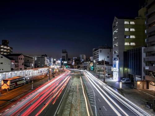 a city street at night with streaks of lights at Kochi Terminal Hotel in Kochi