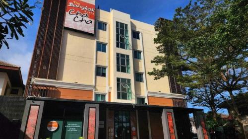 a building with a cocacola sign in front of it at Collection O The Bangkok Cha Cha Suite in Bangkok
