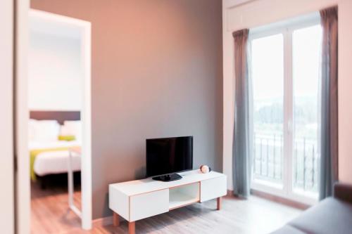 TV a/nebo společenská místnost v ubytování Lux Apartamentos Santiago