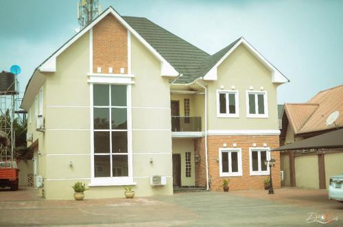 a large white house with a brick at Luxury 4 bedroom apartment in Asaba