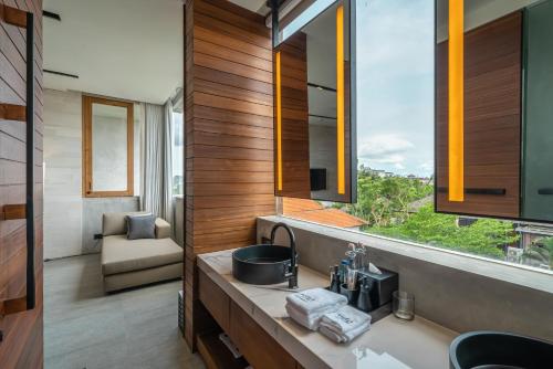 a bathroom with a sink and a large window at Body Factory Lifestyle Residence in Canggu