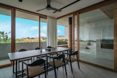 a dining room with a table and chairs at Body Factory Lifestyle Residence in Canggu