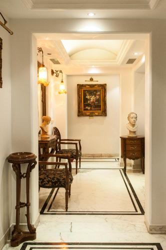 a hallway with chairs and a painting on the wall at Villa 33 in New Delhi