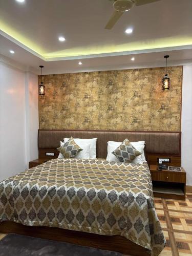 a bedroom with a large bed and a brick wall at Swet Palash Resort in Purulia