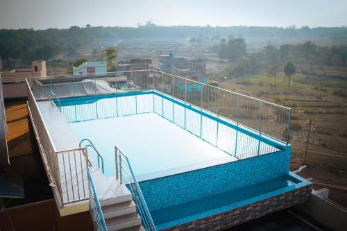 a balcony with a volleyball court on top of a building at Swet Palash Resort in Purulia