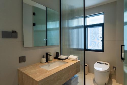 a bathroom with a sink and a toilet at Eden Yard Boutique Hotel and Experiences in Xianghu