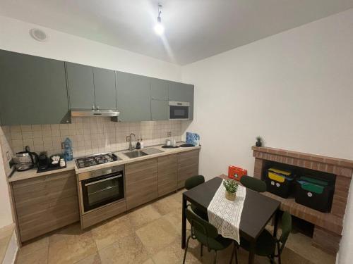 a kitchen with a table and a dining room at La casetta di Fra & Giù in Longobucco