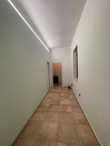 an empty hallway with white walls and a tile floor at La casetta di Fra & Giù in Longobucco