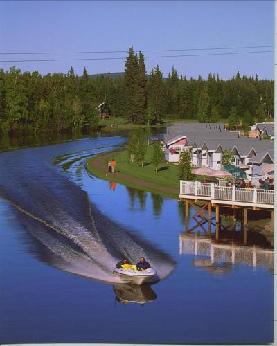 a couple of people in a boat on a river at River's Edge Resort in Fairbanks