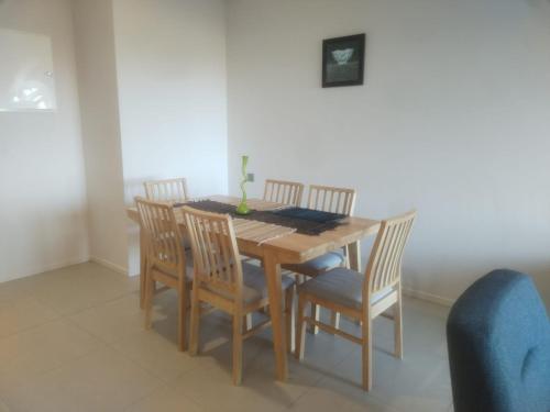a dining room table with four chairs and a table and chairsuggest at Sky Sunrise two rooms apartment in Moka