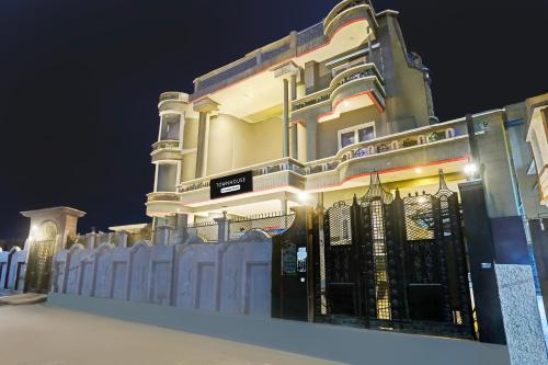a building with a gate in front of it at night at Super Townhouse Vijay Khand Gomti Nagar in Lucknow