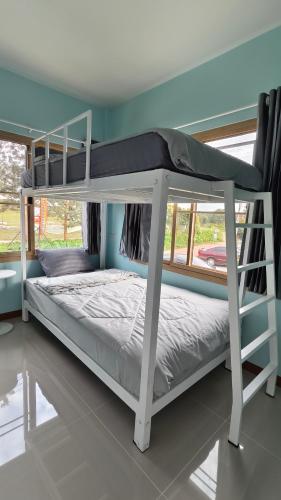 a white bunk bed in a room with a window at โซพราว เขาค้อ So Proud Khaokho in Khao Kho