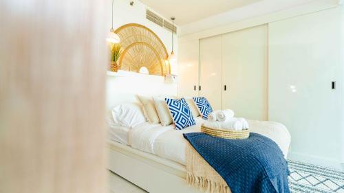 a white living room with a white couch at Studio In Al Hadeel Hosted By Voyage in Abu Dhabi