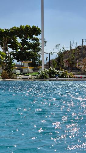 a swimming pool with blue water in a city at مزرعة-جوري--Jory-Farmhouse in Hatta