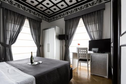 1 dormitorio con 1 cama, 1 mesa y 1 silla en Residenza Scipioni Luxury B&B, en Roma