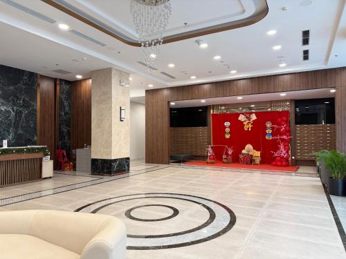 a lobby with a large rug on the floor at Vinhomes Sky Park Bac Giang by QMP in Bắc Giang