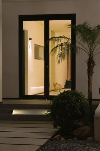 a room with a window with a cat in the background at Eden Yard Boutique Hotel and Experiences in Xianghu