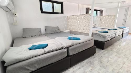 a bedroom with two beds with blue pillows on them at โซพราว เขาค้อ So Proud Khaokho in Khao Kho